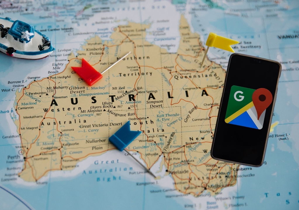 Map of Australia with pins and a phone showing the Google Maps logo